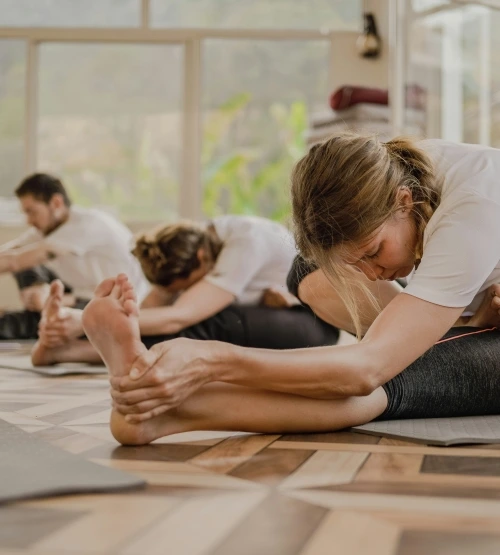 Group stretching during a restorative yoga class