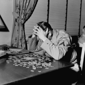 man putting puzzle together