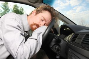 Truck driver asleep behind the wheel