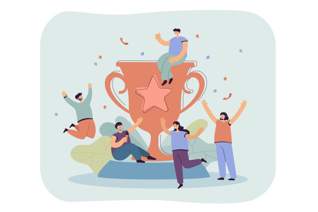 A cartoon illustration of four joyful people celebrating around an oversized trophy with a star, with one person sitting on top and others jumping and cheering nearby with confetti falling, representing a team award or group recognition achievement.